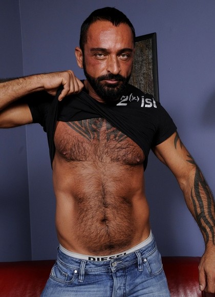 Gay construction worker Tom Colt strips & shows his hairy inked body & cock
